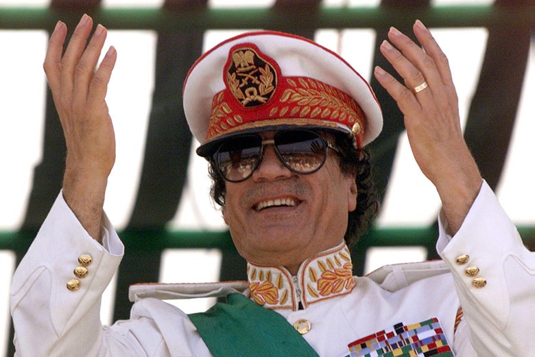 TRIPOLI, LIBYA: Libyan leader Moamer Kadhafi salutes his troops participating 07 September 1999 in a military parade in Tripoli to mark the 30th anniversary of the Libyan Revolution that brought Kadhafi to power. Troops from 24 African states joined the flamboyant, five-hour parade which also heralds this week's extraordinary summit of the Organisation of African Unity (OAU). (Photo credit should read MARWAN NAAMANI/AFP/Getty Images)